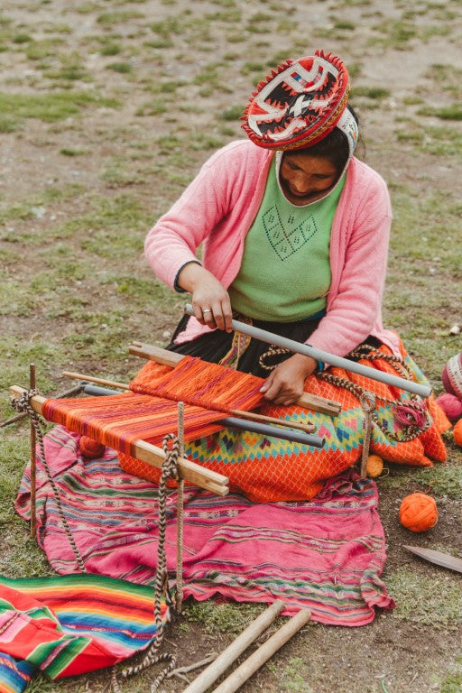 Artisan weaving on a traditional backstrap loom in the Sacred Valley