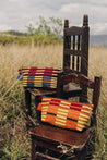 Styled of Weekender Cosmetic Pouch Djion and Cabernet on Wooden Chairs
