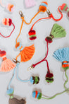 flatlay of colorful collection of artisan made pom tassel keychains