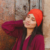 Wayra Twist Alpaca Beanie Bright Orange Color Made by Awamaki Peru Styled by Model in the Sacred Valley